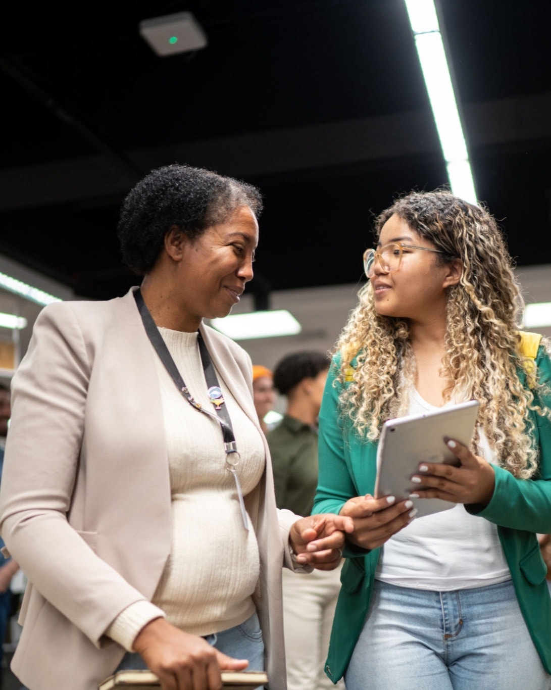 Mentor and student walking together on campus